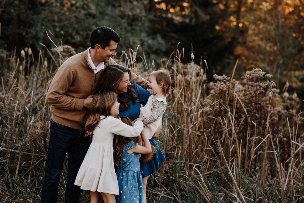 A series of candid family moments captured in an outdoor setting with tall grass.