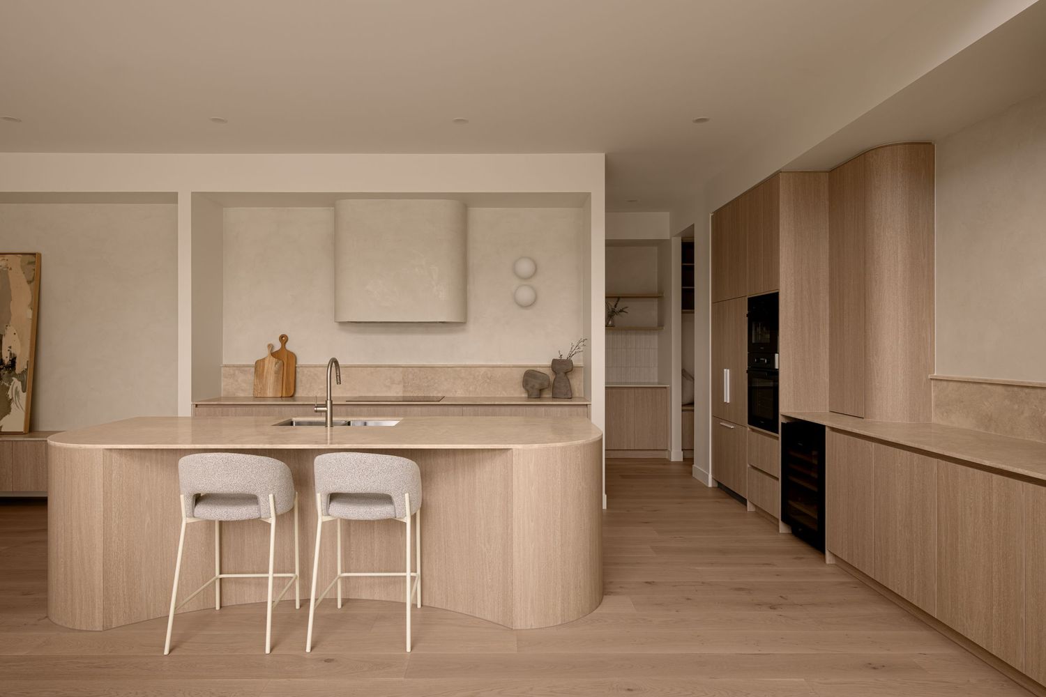 Modern minimalist apartment interior with light wood paneling and white walls features open concept living spaces.