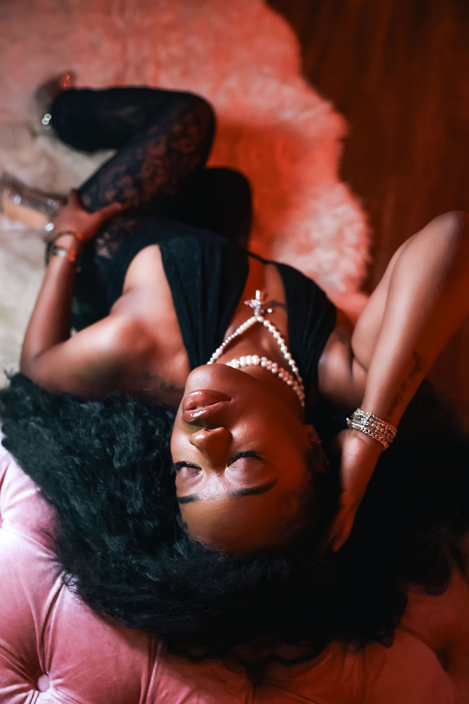 A series of artistic boudoir portraits showing a figure reclining against pink fabric with dramatic lighting.