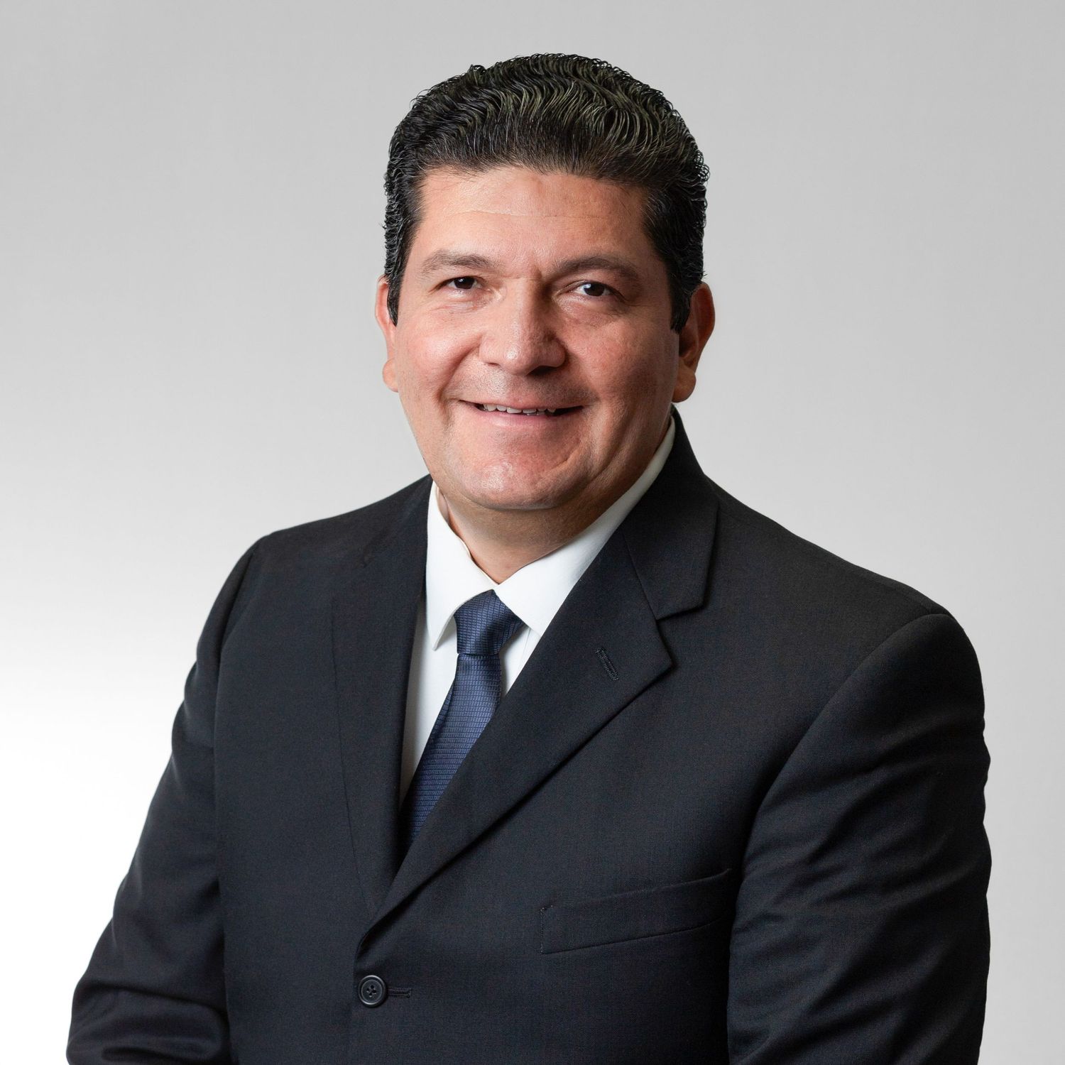 Professional headshot series showing person in dark business suit against gray background.