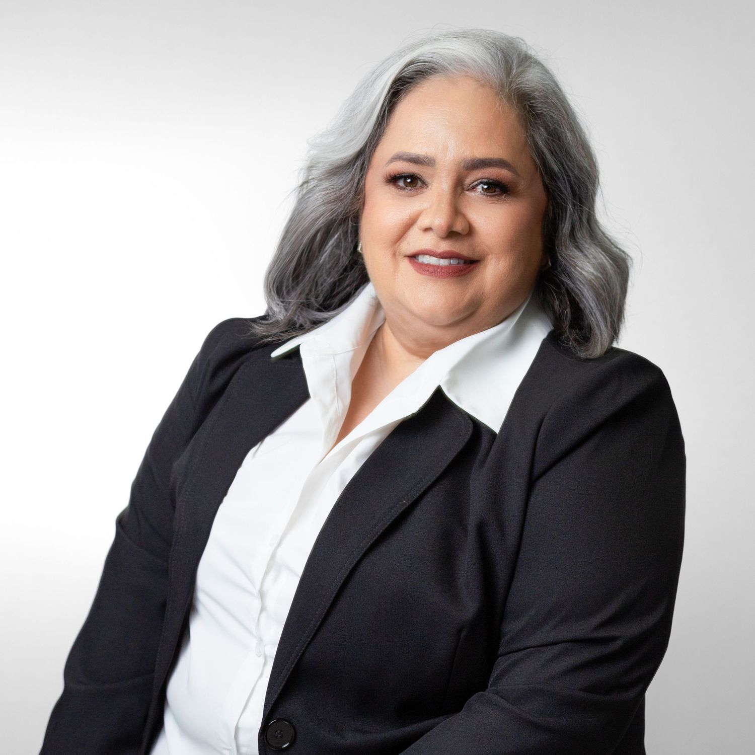 Professional woman in black blazer and white blouse shown in four different poses against light background.