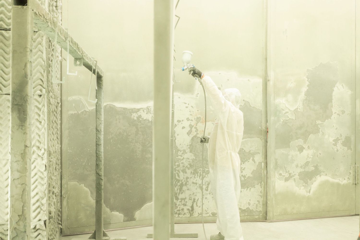 Long corridor view of a sterile manufacturing facility with white walls and equipment.
