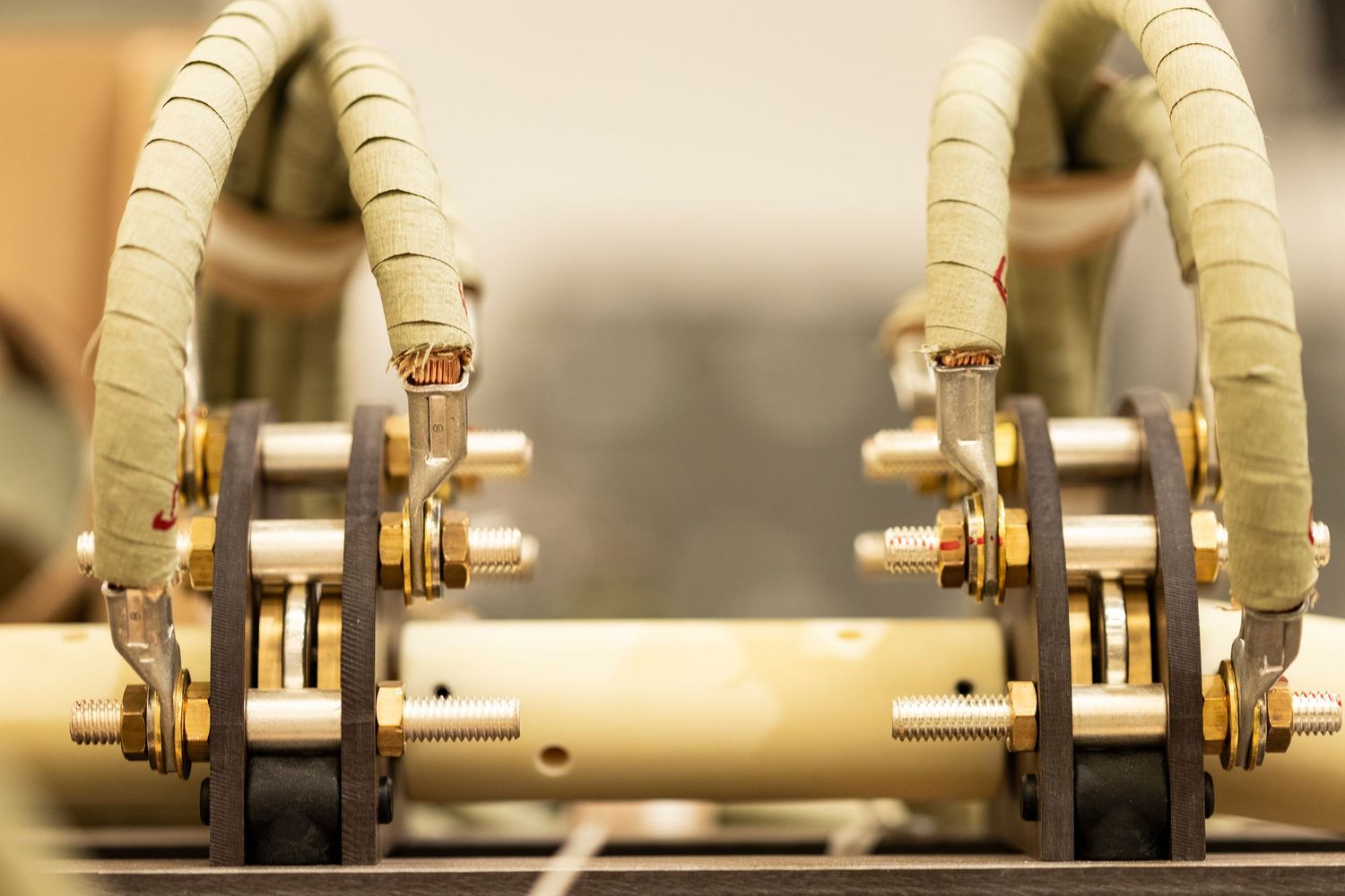 Close-up of mechanical components showing beige rollers and metal fixtures in sequence.