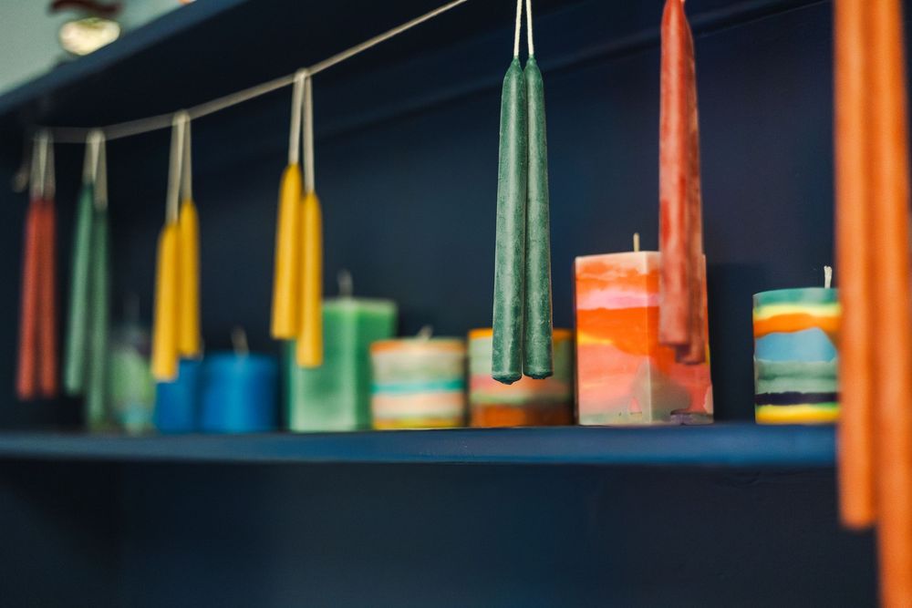Row of hanging orange and yellow objects create a linear pattern against a dark blue background.