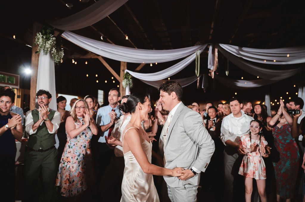 Wedding celebration with guests gathered in a circle on the dance floor of a rustic barn venue at Fortune Valley Manor in Saugerties, NY.