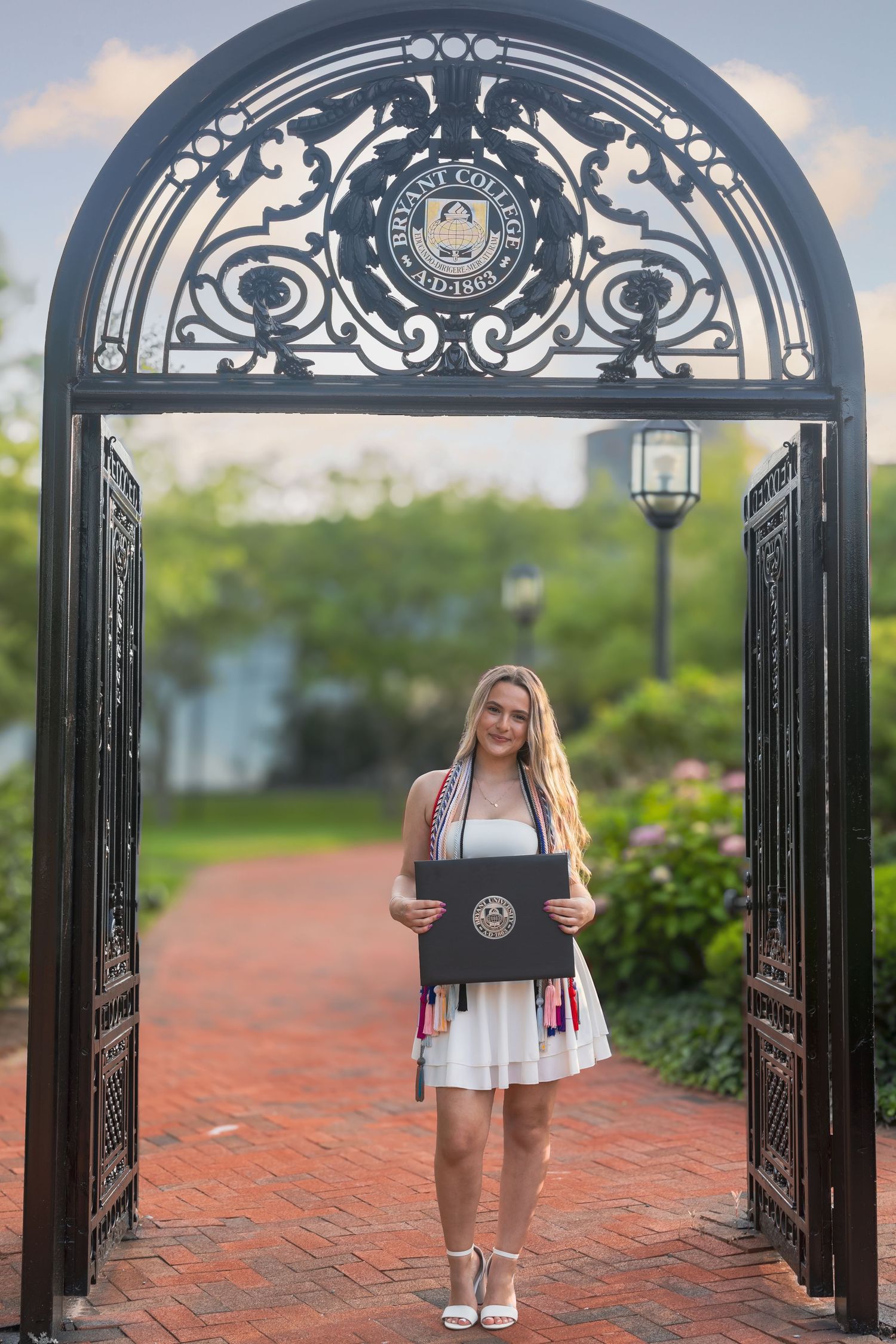 A series of wedding photos showing ornate gates, decorative clocks, and romantic outdoor settings at a venue.