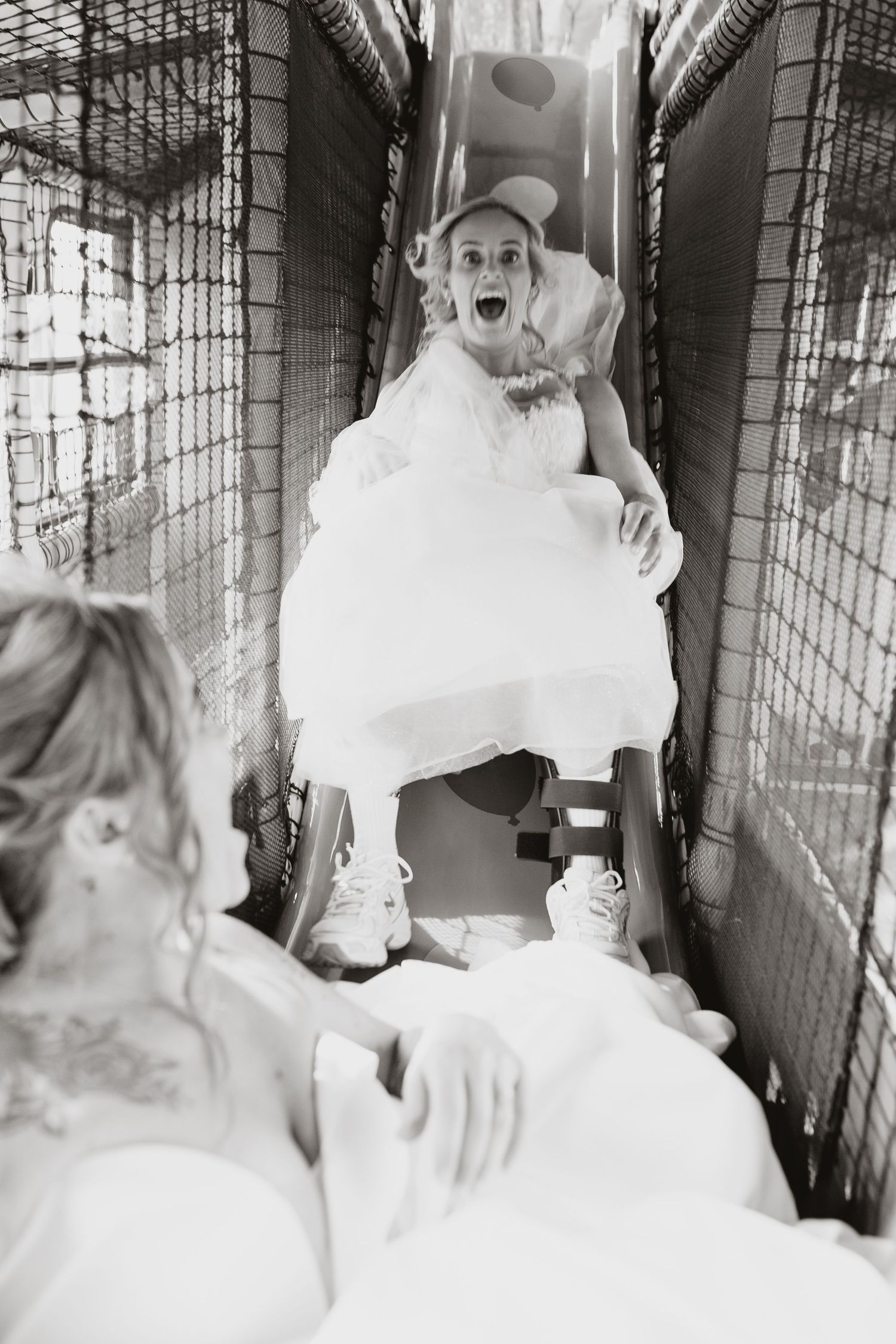 Black and white photo of bride playing on play bus at Stanford Farm