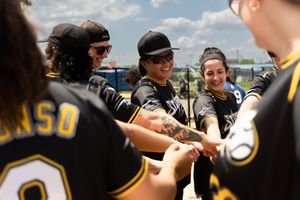 Lesbian soft ball team in candid picture of sports league documentary photography by trans photographer Kade Joy.