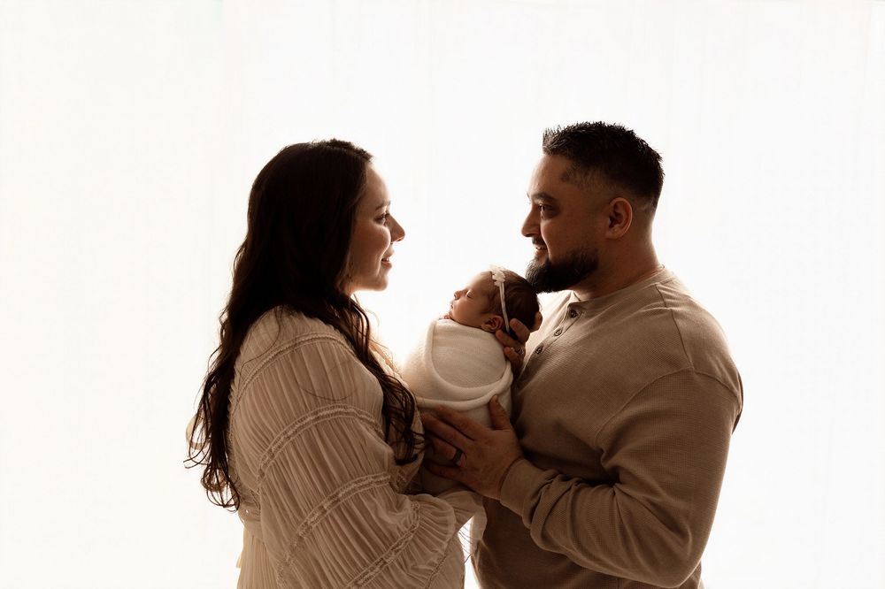 A couple in beige sweaters dances together in a romantic sequence of poses against a white background.