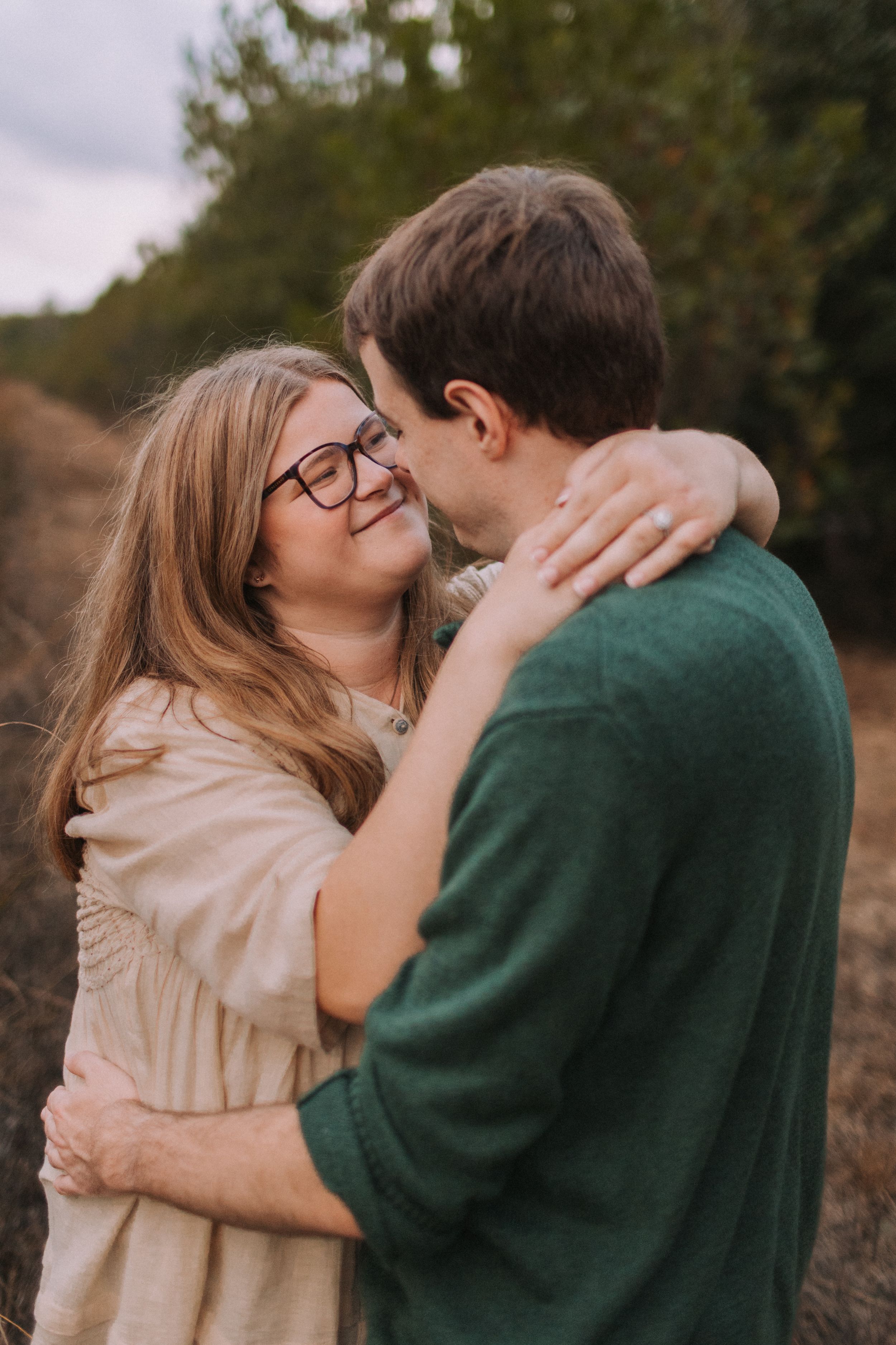 Intimate candid moments captured between a couple in an autumn setting.