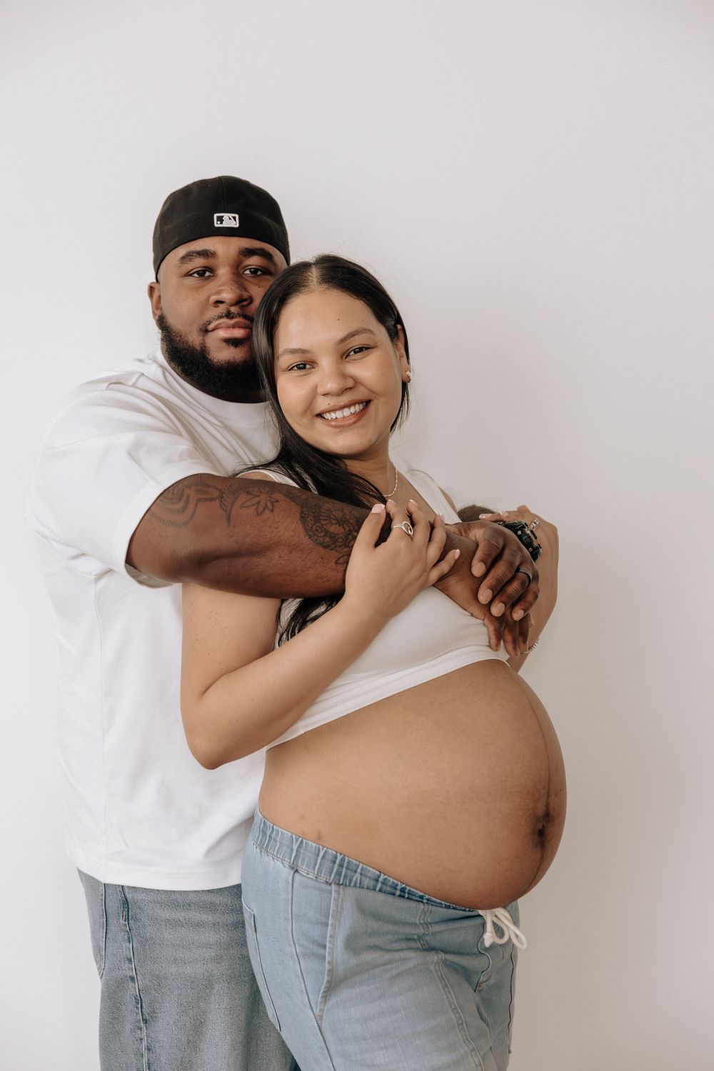 Lifestyle maternity photos showing natural interaction in a Rochester, NY studio