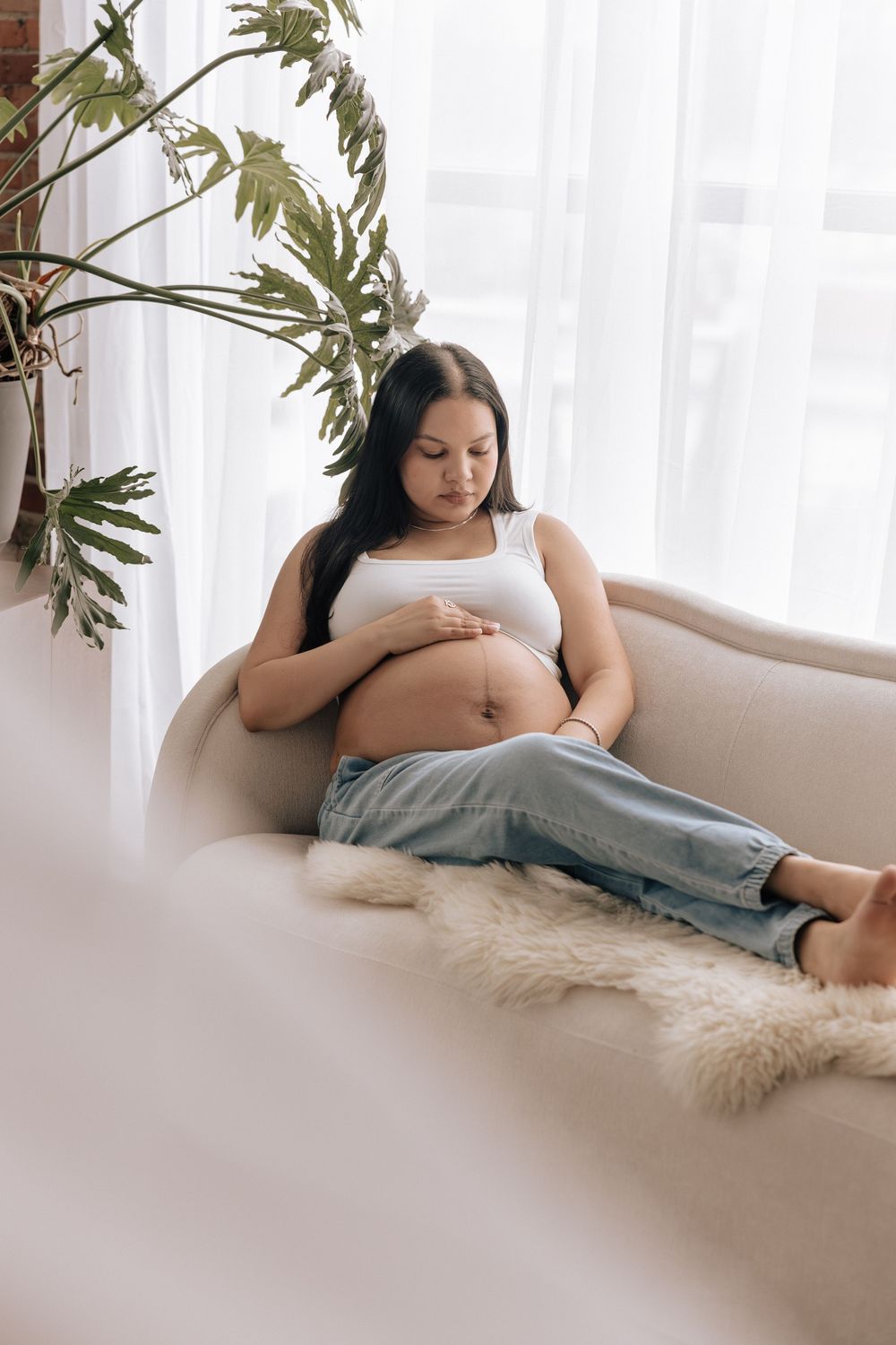 Intimate moment of expecting mom during a maternity session in Rochester