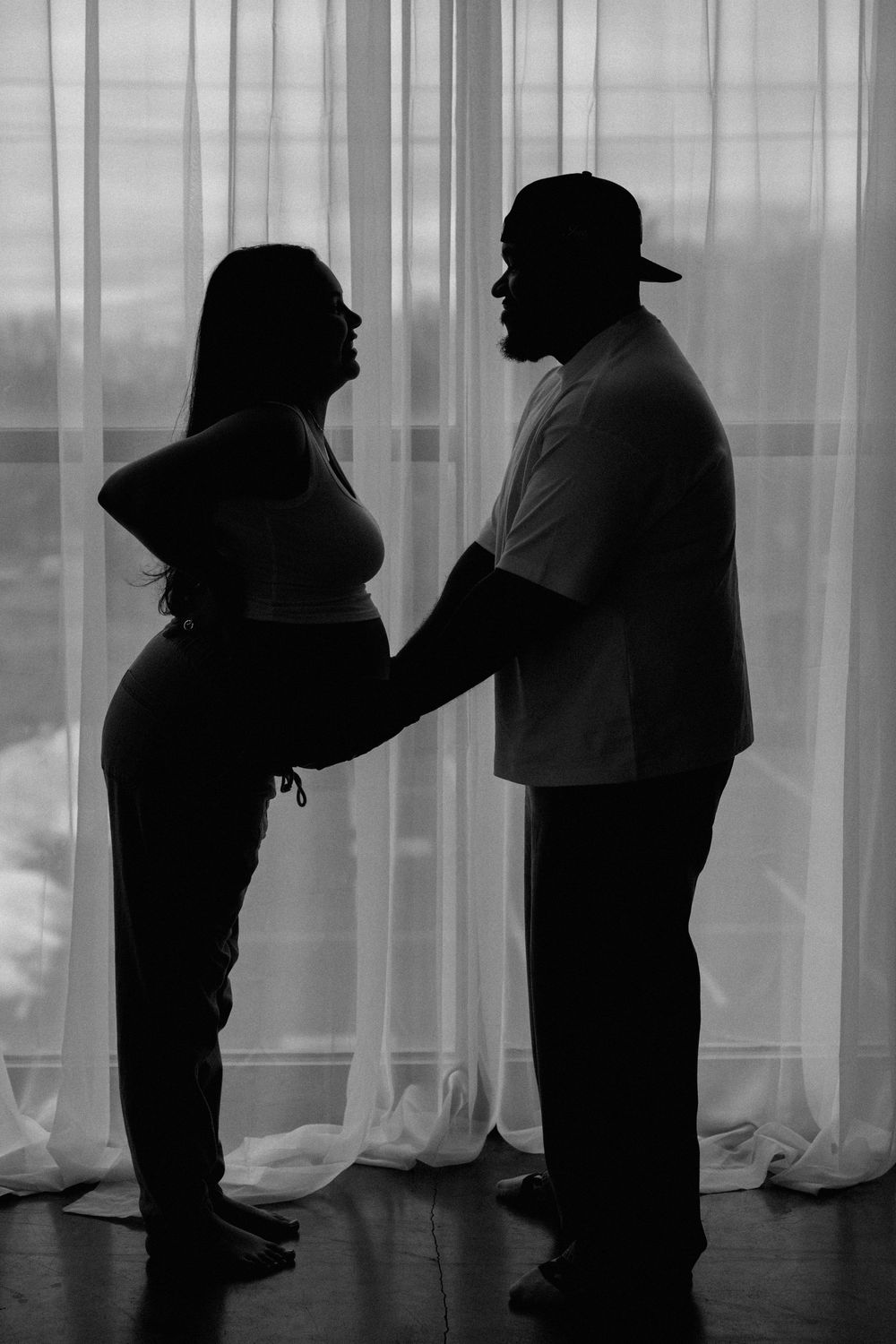 Lifestyle maternity photographer in Rochester capturing candid studio moments