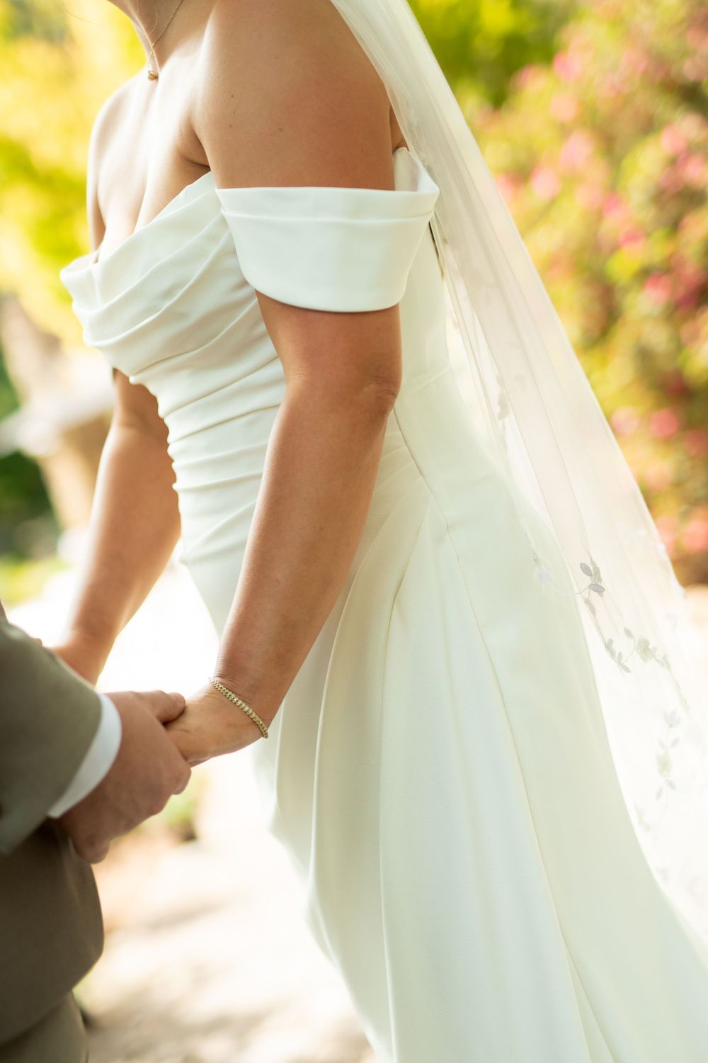 Simple elegant white wedding dress detail shots showing fabric texture and silhouette.
