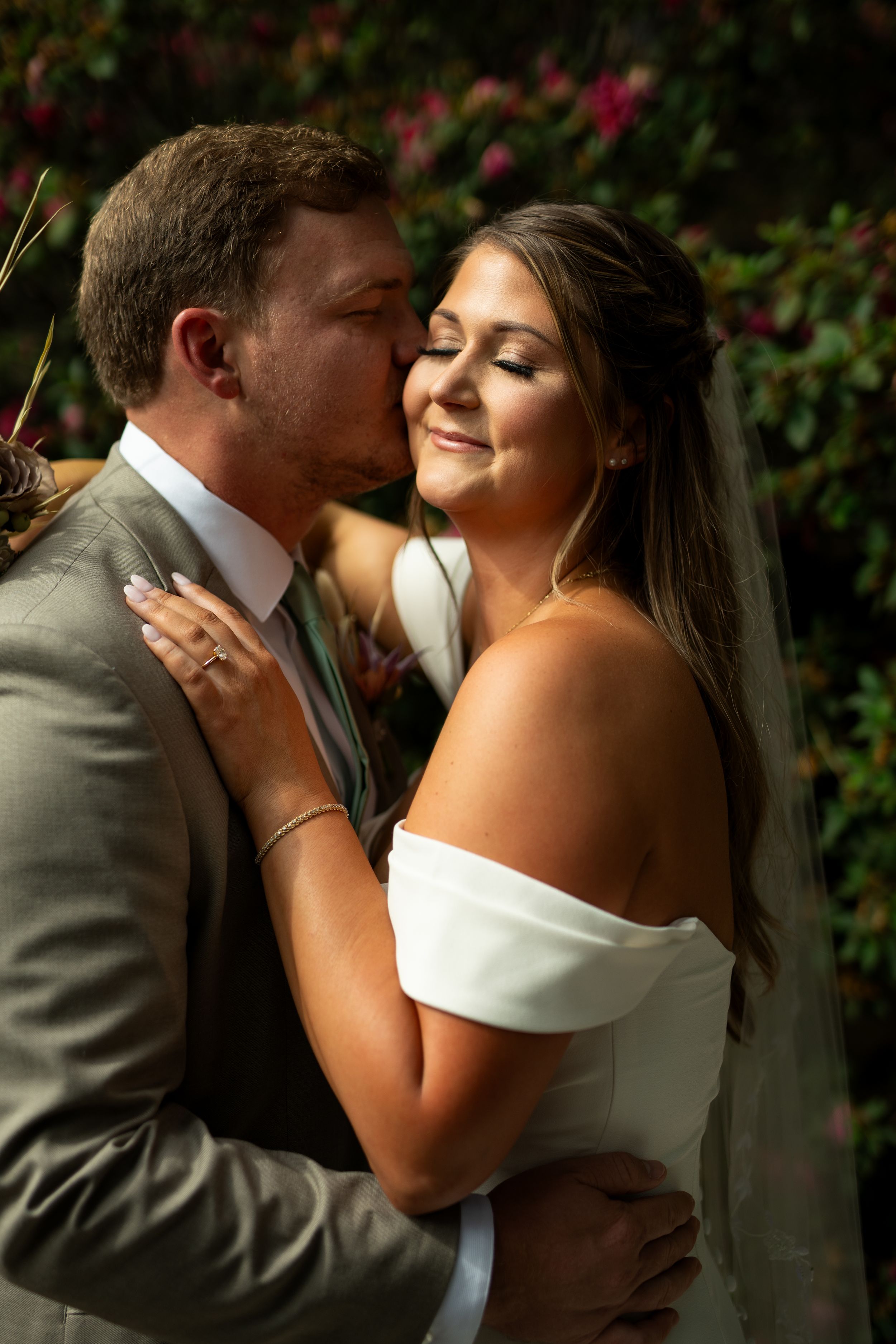 Wedding couple shares intimate moments during romantic outdoor photo session.