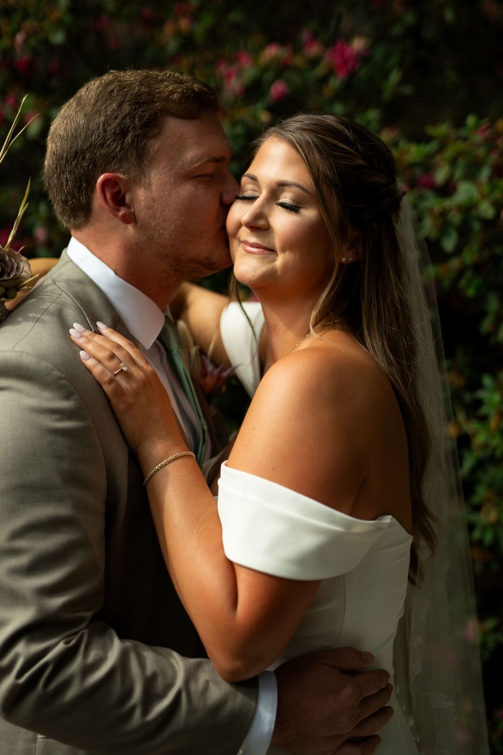 Wedding couple shares intimate moments during romantic outdoor photo session.