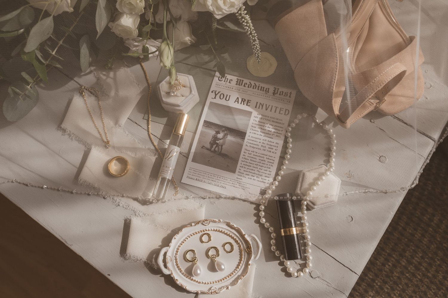 Wedding details including flowers, decor, and table settings arranged in a romantic vintage style.