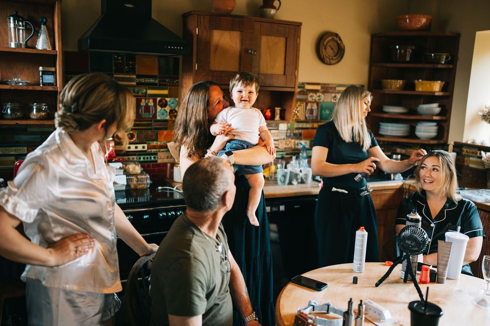 Casual gathering of people socializing in a cozy kitchen setting.