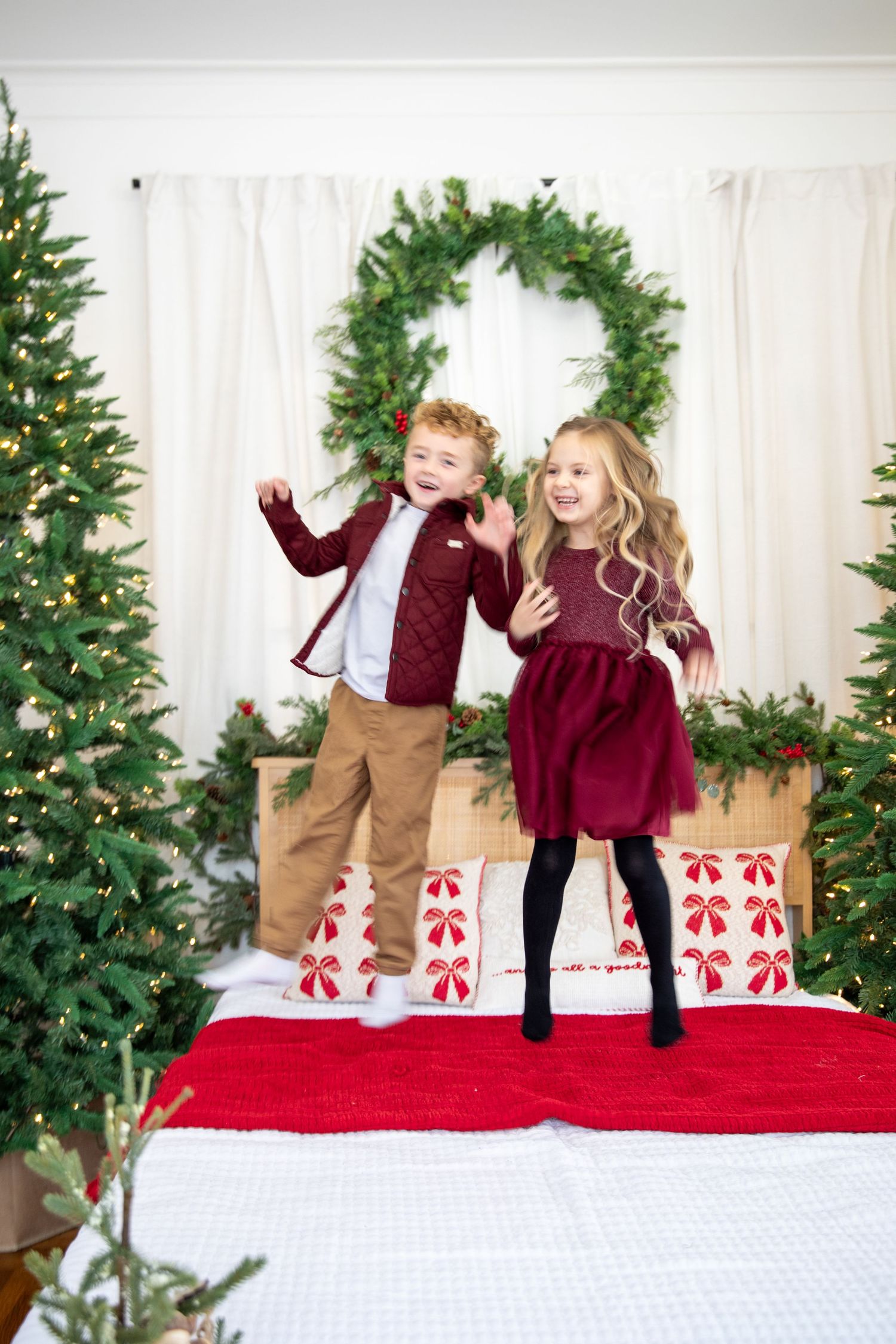 Middletown Christmas minis featuring kids jumping on bed holiday photography with playful candid moments and joyful seasonal storytelling