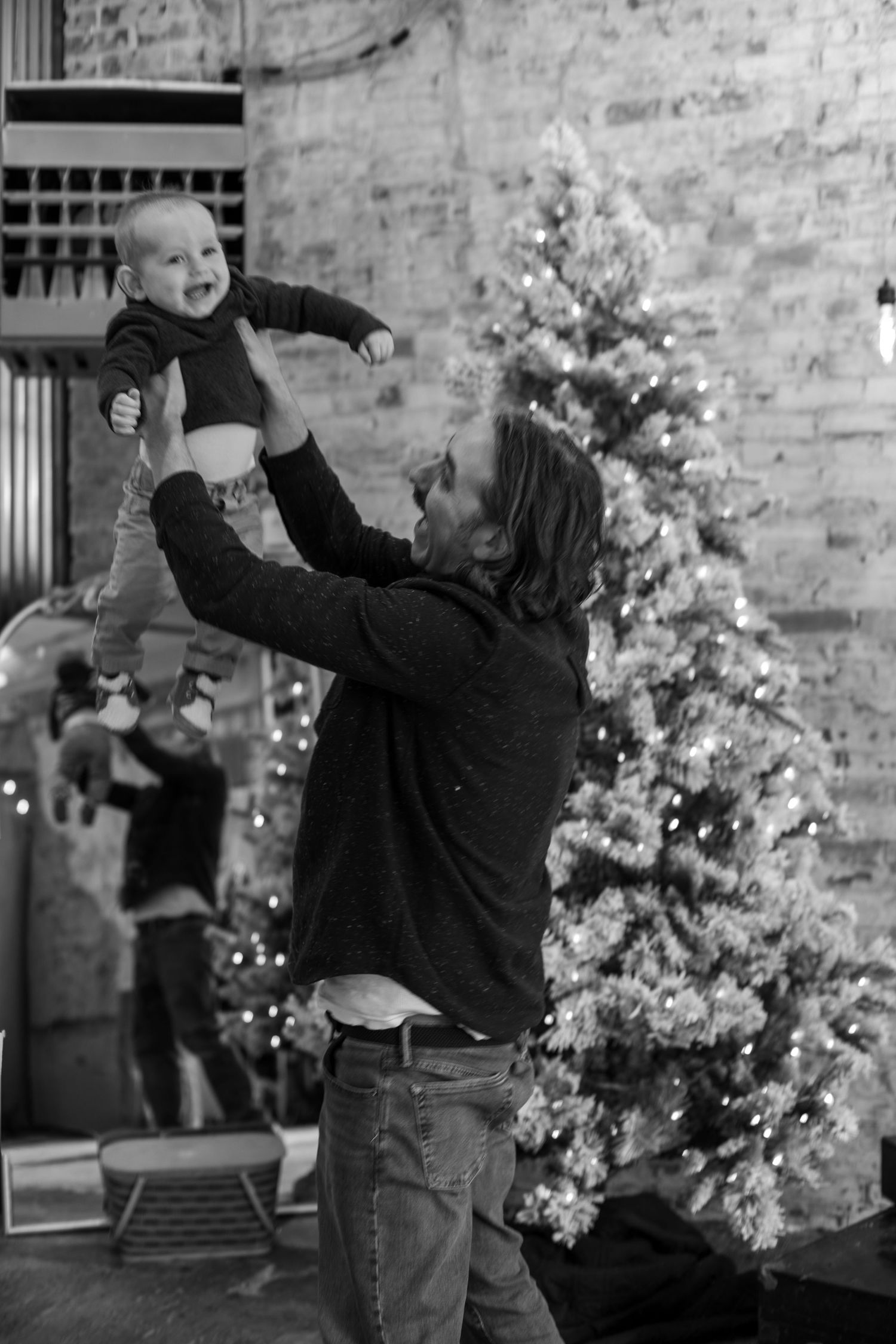 Christmas photography in Cincinnati featuring dad and baby holiday portraits with natural emotion, festive styling, and warm seasonal storyt