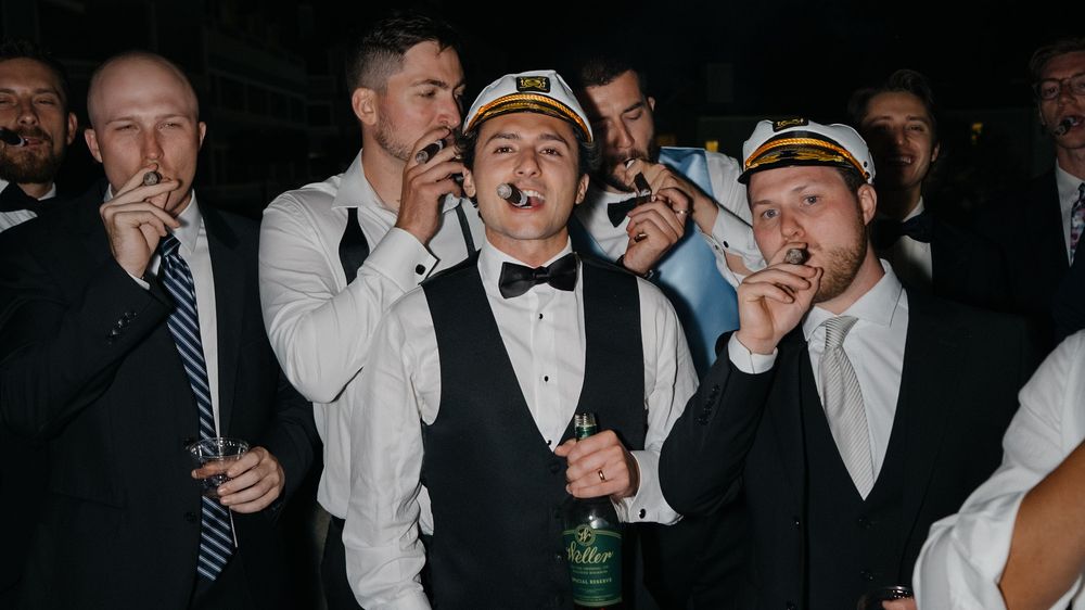 Group of people celebrating and posing together at a festive nighttime event.
