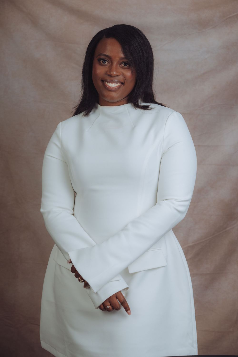 Artistic fashion photo featuring white turtleneck sweater against textured background.