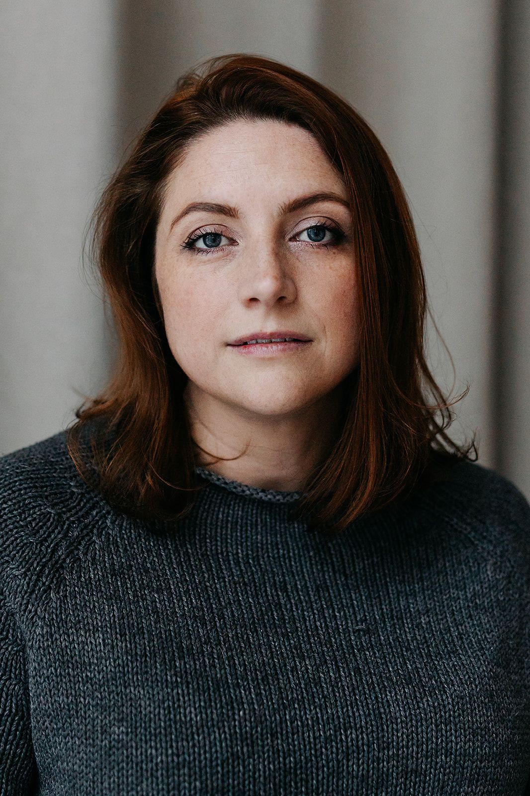 A sequence of portrait shots showing someone in a gray sweater with changing expressions against a neutral background.