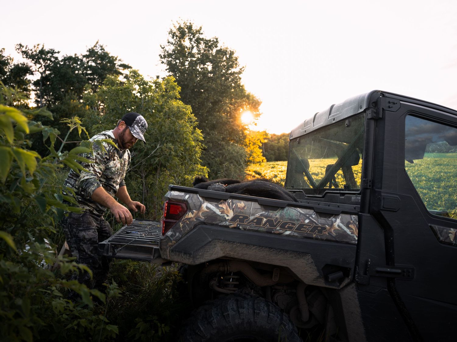 Photography equipment mounted on a vehicle during golden hour in nature.