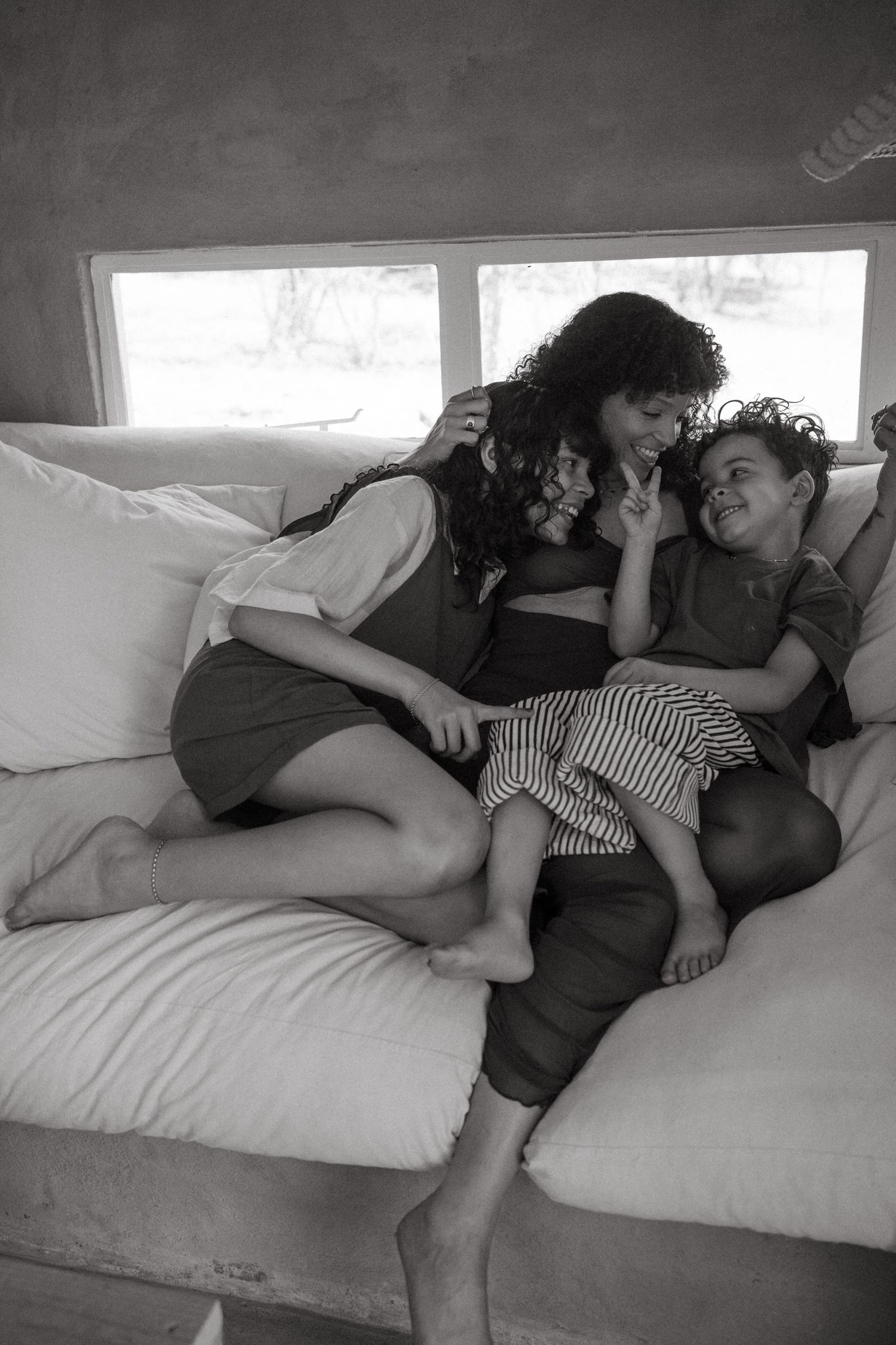 Black and white photo series of a couple cuddling and sleeping together on a bed.