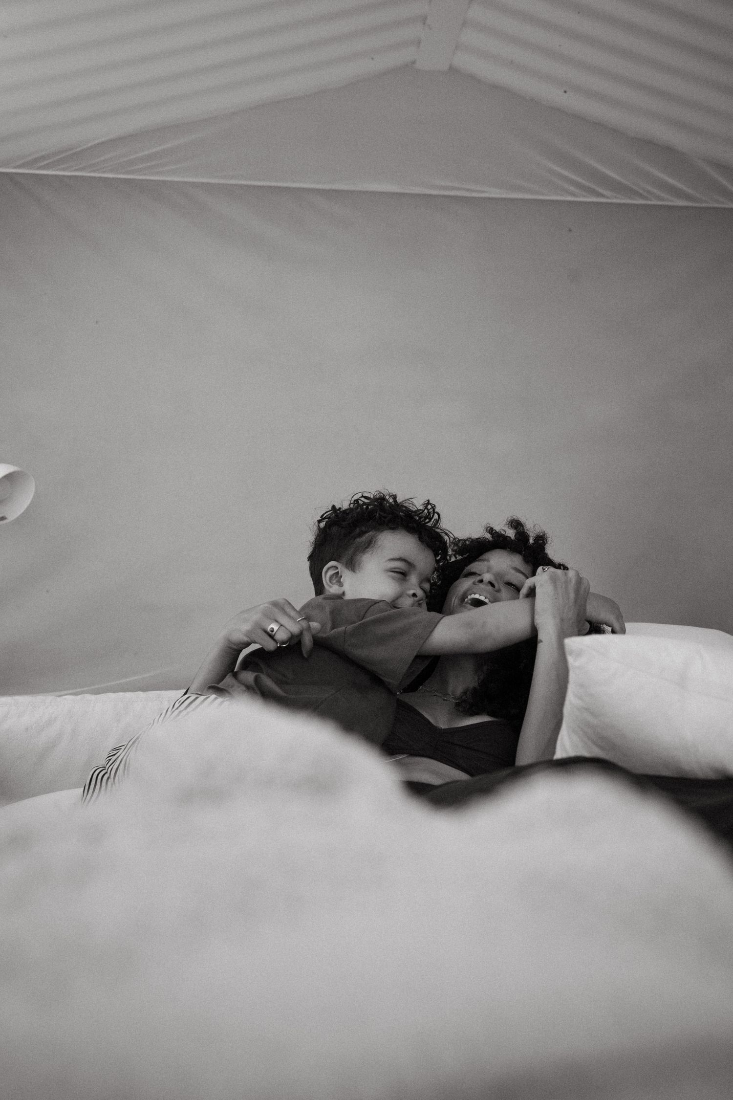 Minimalist black and white photos showing quiet moments of rest on white bedding.