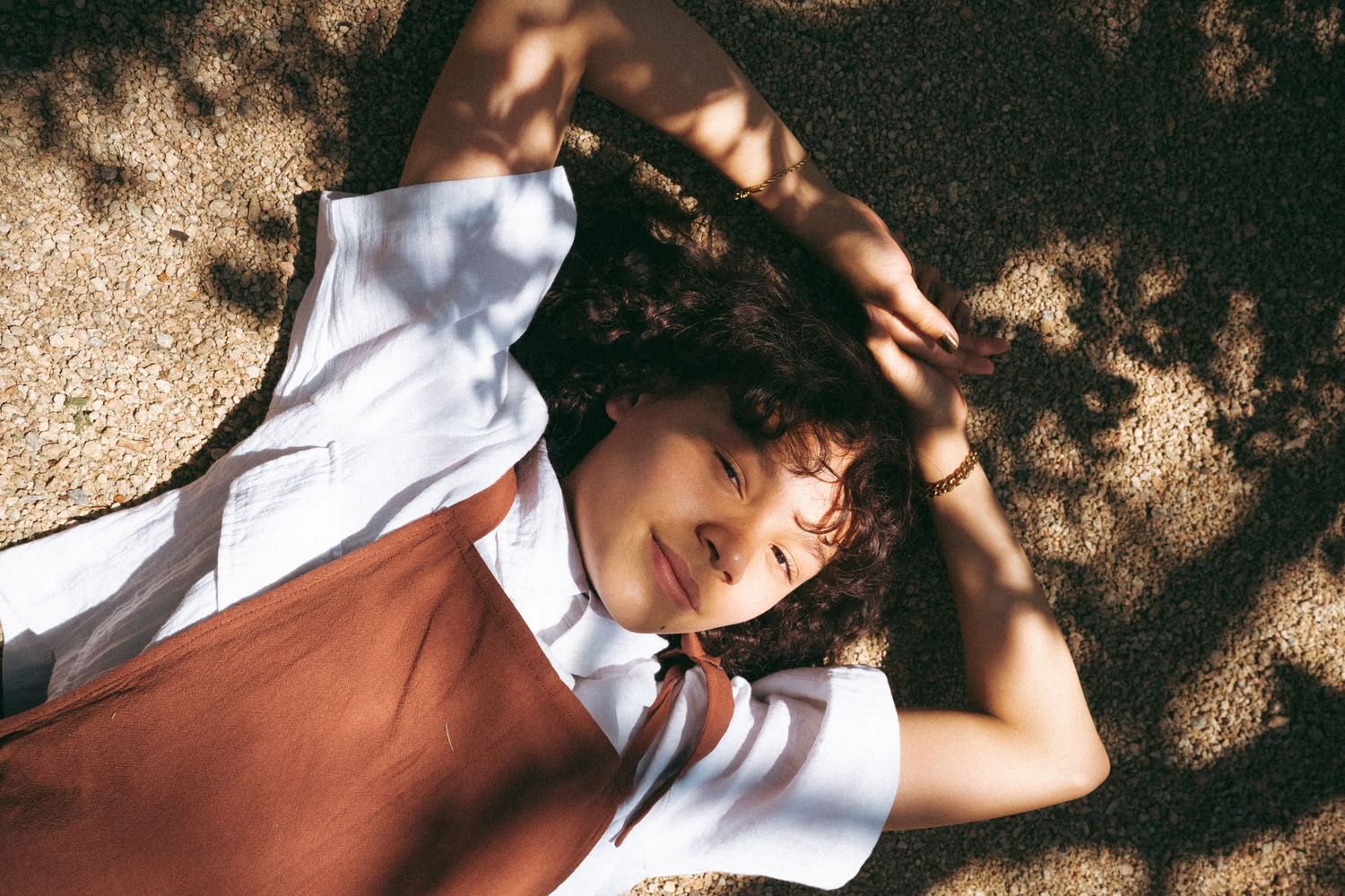 Outdoor portrait series with natural dappled sunlight creating artistic shadows.