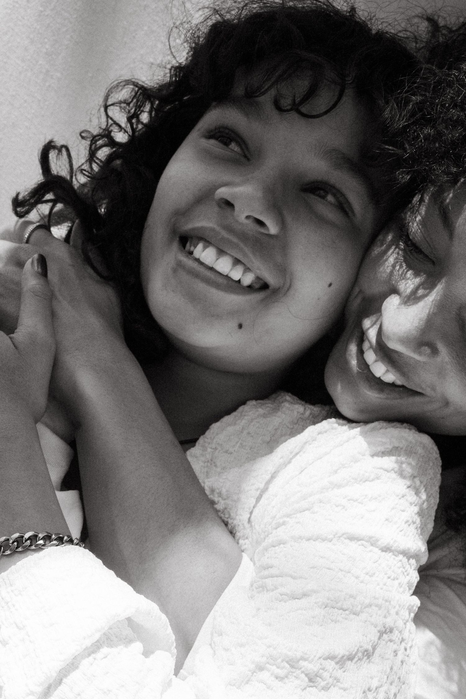 Close-up black and white portrait shots showing joyful expressions.