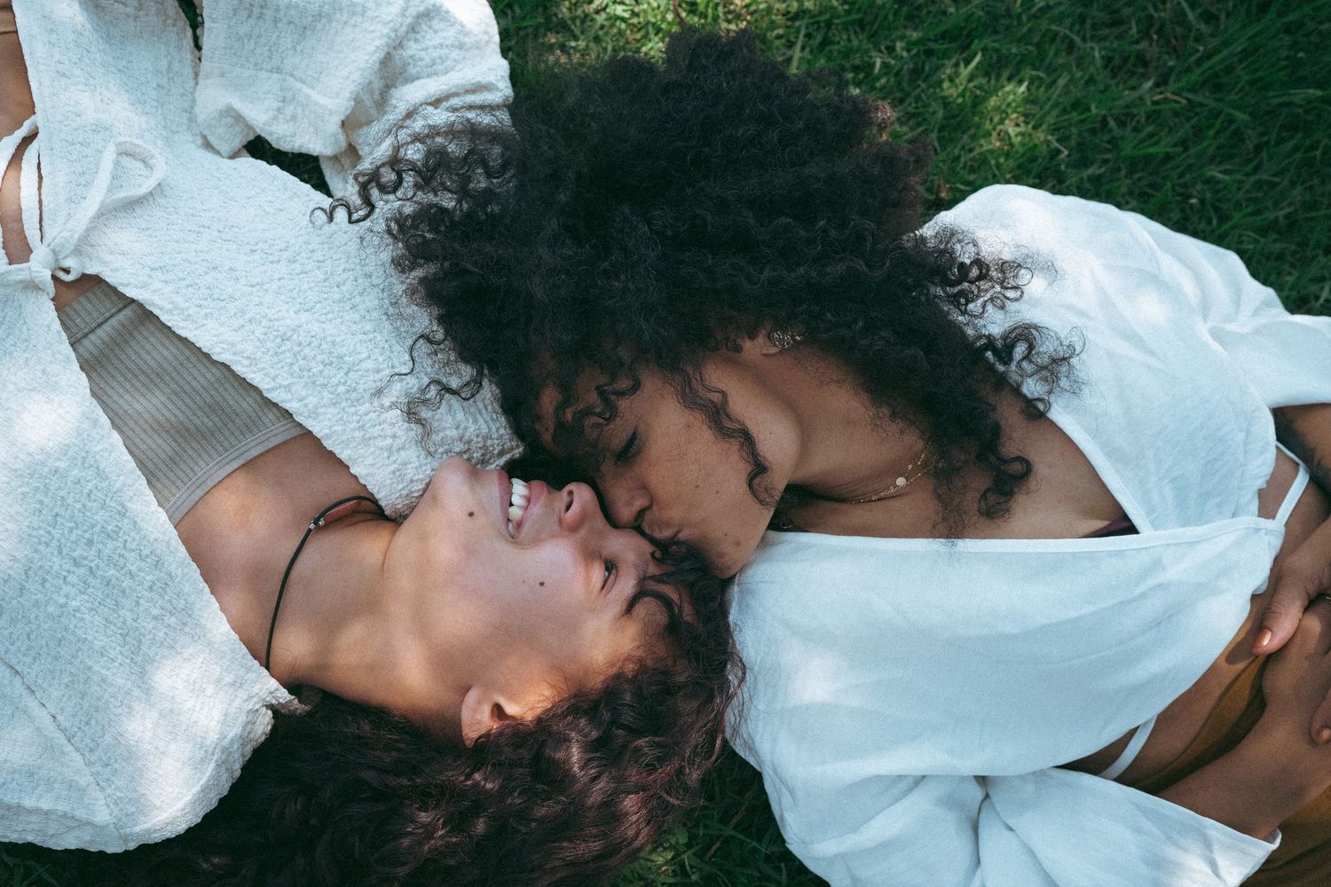 Intimate artistic portraits taken in soft natural lighting against grass and foliage.