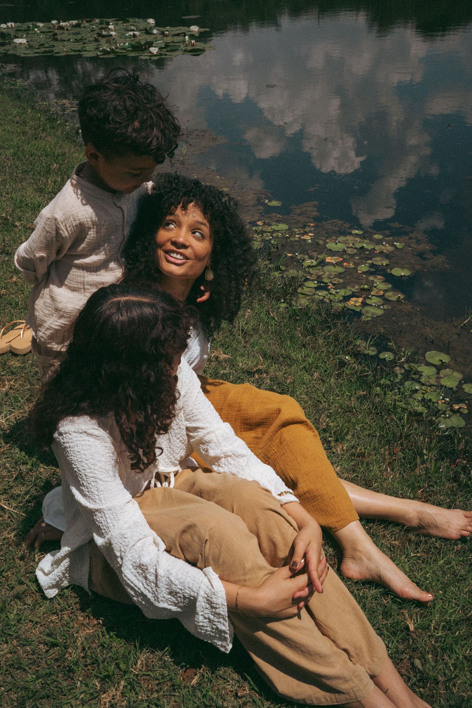 Romantic lakeside portraits with white lace and mustard yellow clothing against nature.