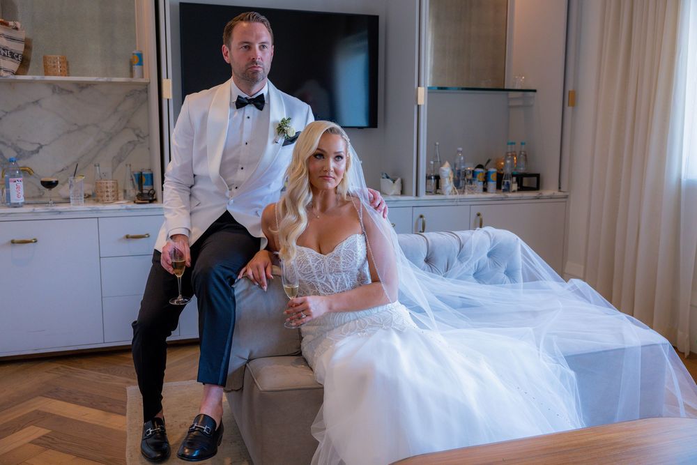 Bride and groom sitting on couch in Miami