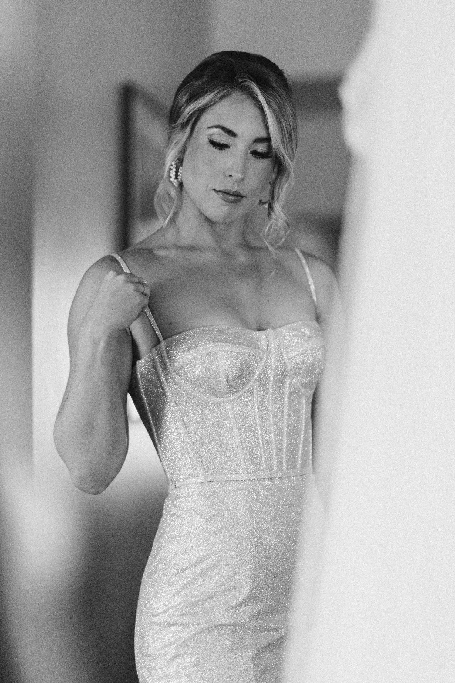 Black and white portrait showing details of a beaded wedding dress.