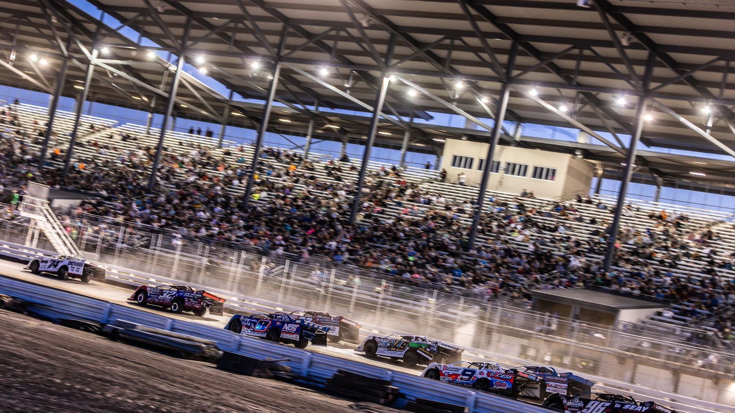 Panoramic view of a packed indoor stadium arena with rows of seats filled with spectators during an event.