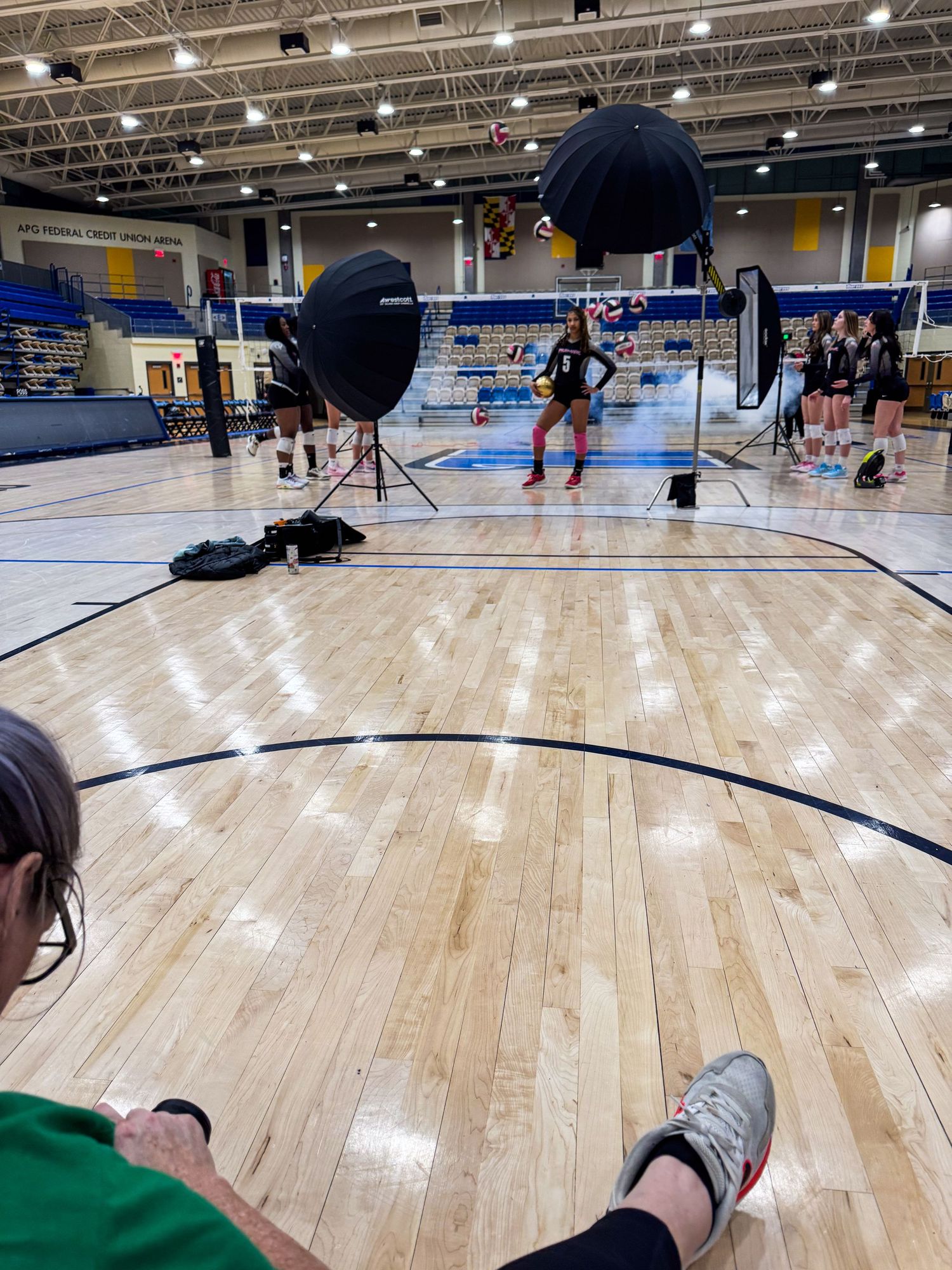 Sequence of indoor gymnasium floor shots showing polished hardwood basketball court surfaces from different angles.