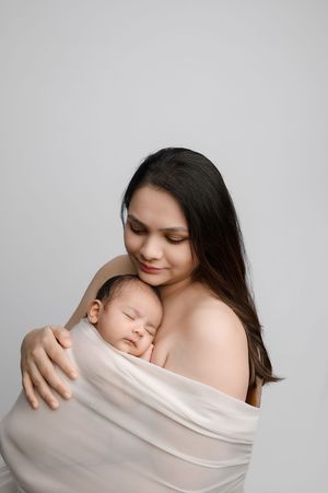 A series of intimate black and white photographs showing tender moments between mother and sleeping newborn baby.