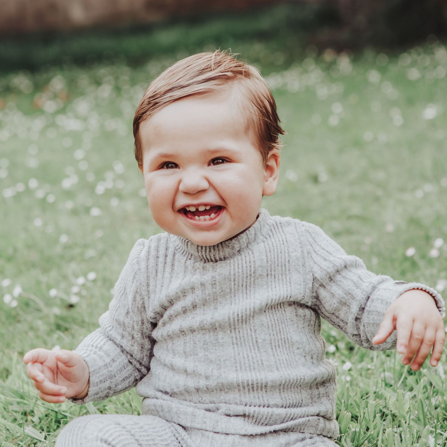Little boy laughing in a field.