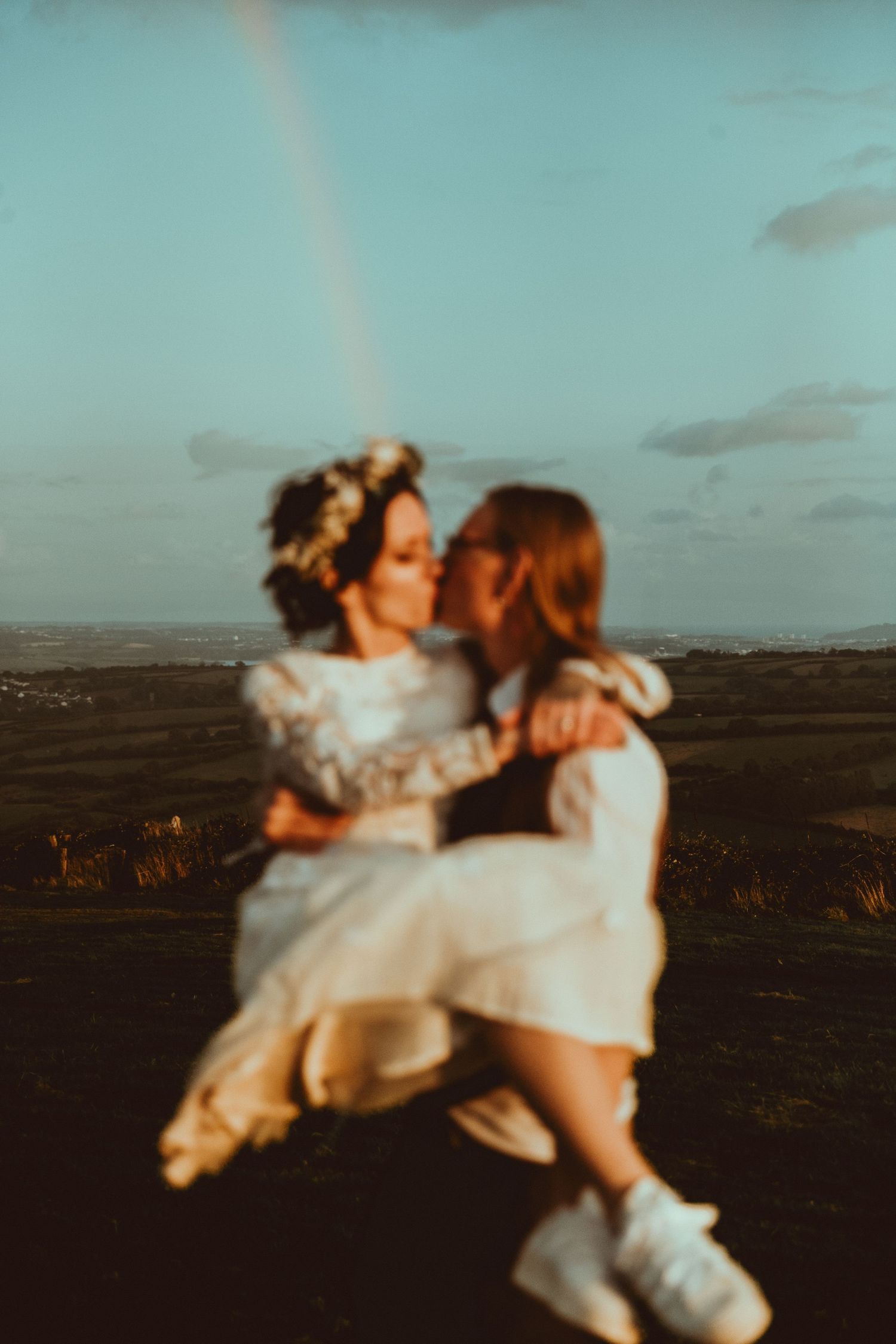 A couple shares intimate moments in a series of candid outdoor photos against a scenic landscape at sunset.