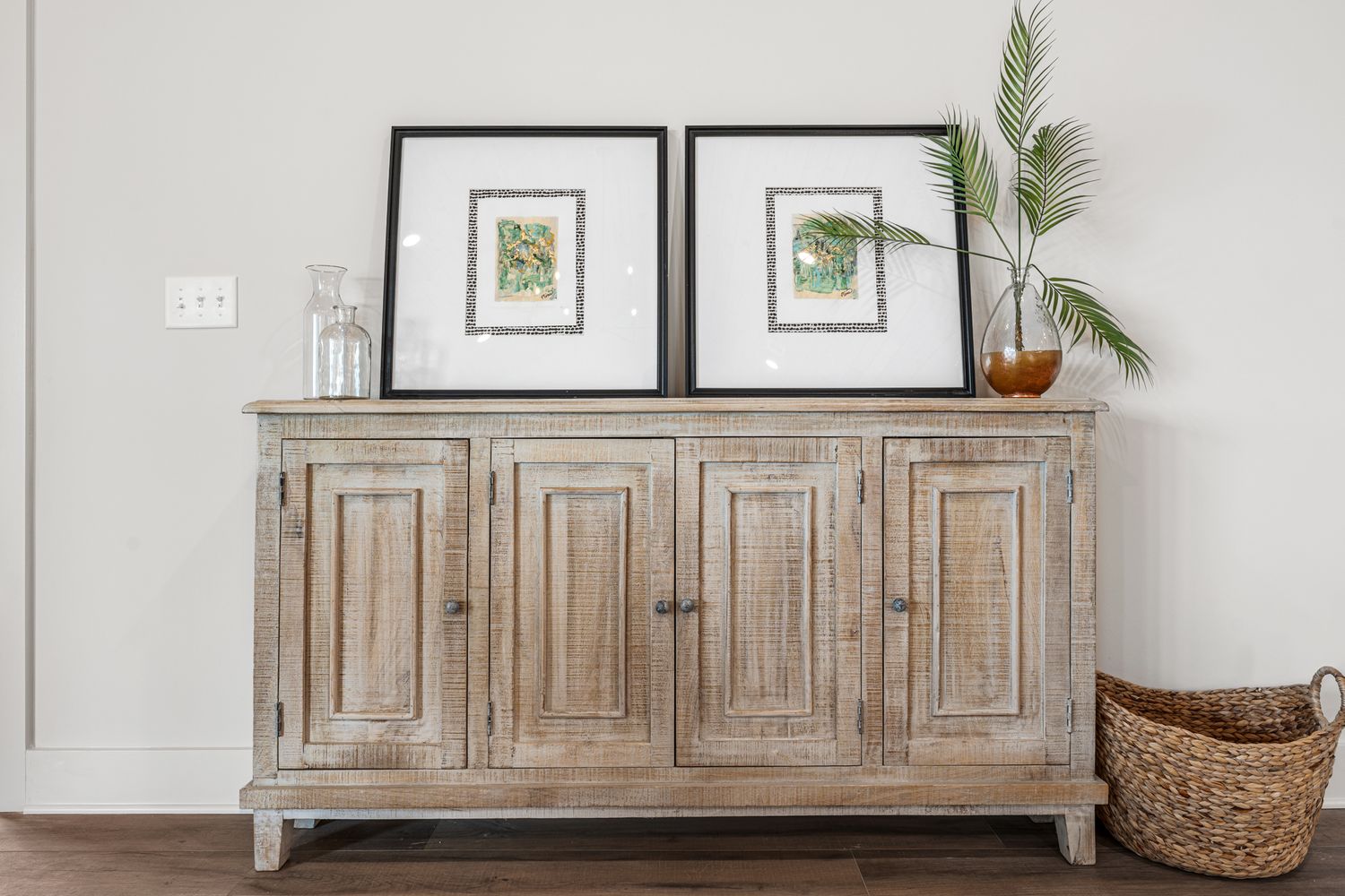 Rustic wooden console table with decorative elements against white walls in a modern living space.