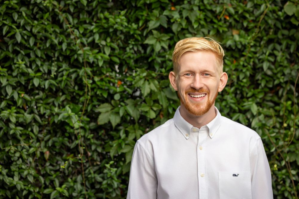 Series of outdoor portraits with green foliage backdrop showing person in crisp white shirt.