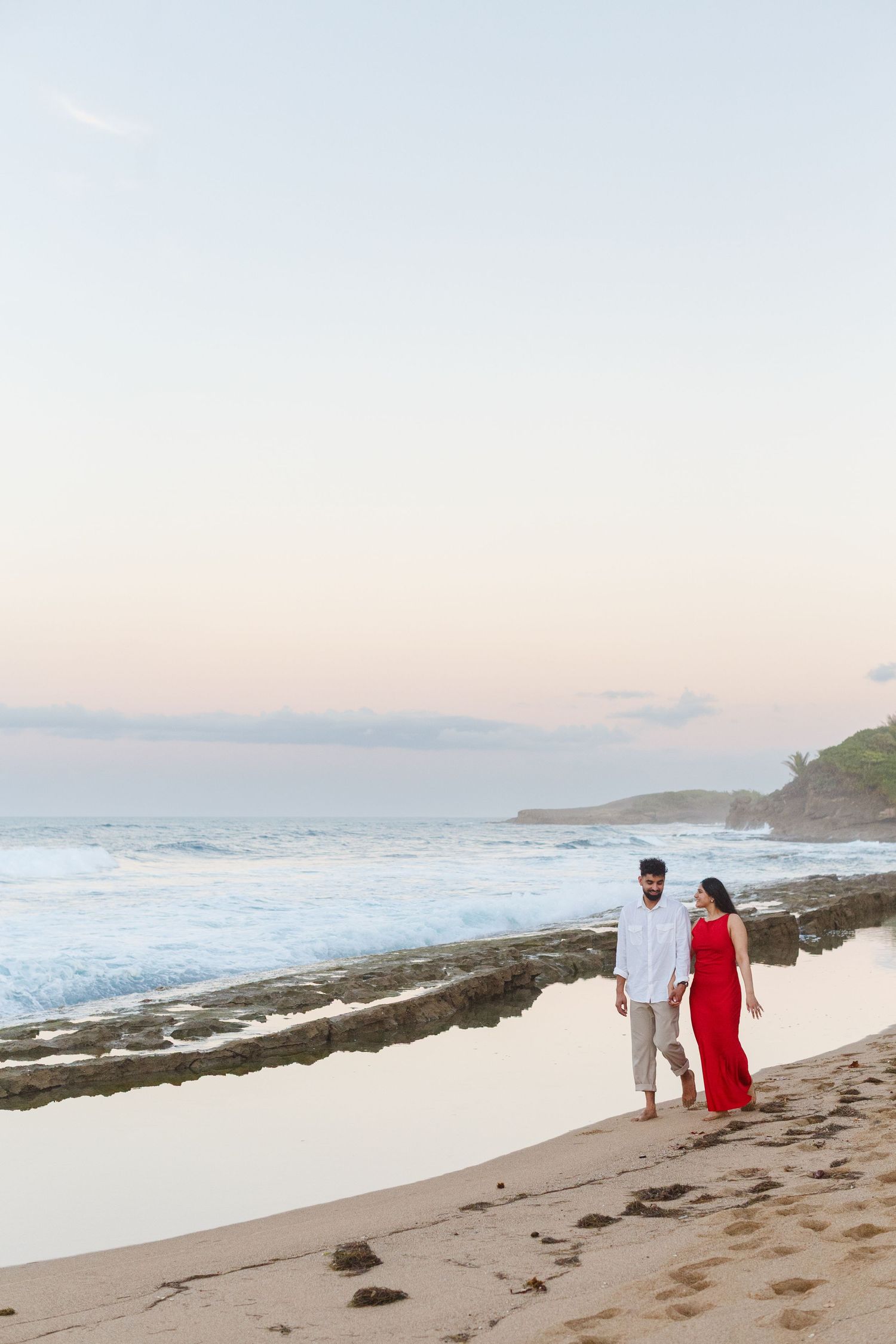 Couples portrait. Proposal and engagement session. Man and woman walking on the beach. Kikita Surf Beach, Dorado, Puerto Rico.