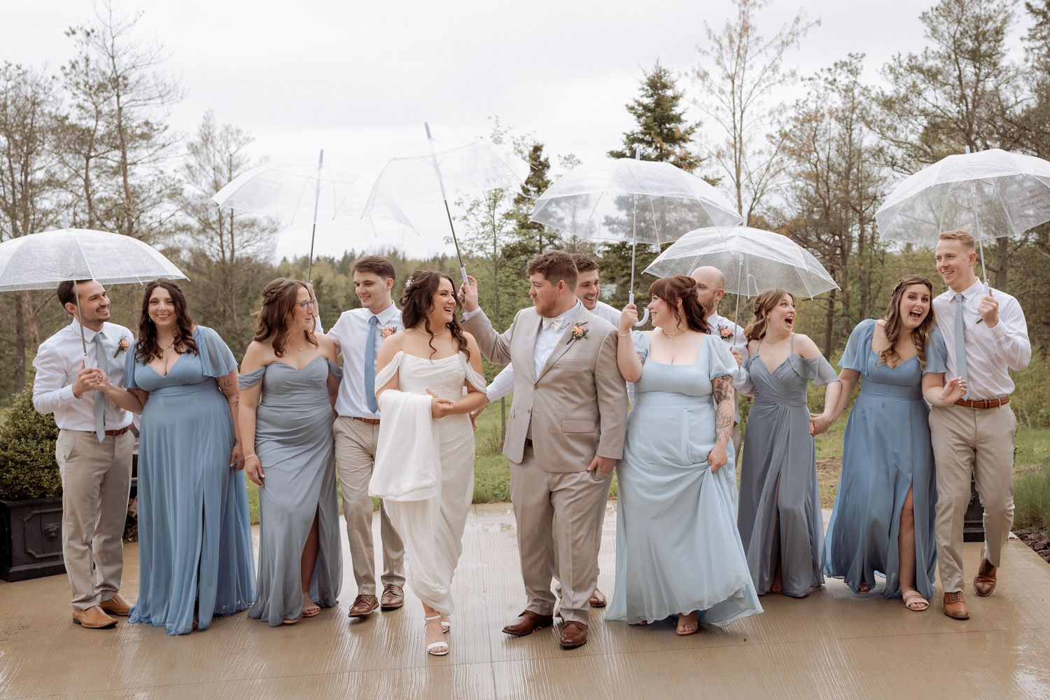 wedding party walks in the rain at Cidery at 51 Acres, spring wedding in Moncton, outdoor wedding portraits in May, New Brunswick photos
