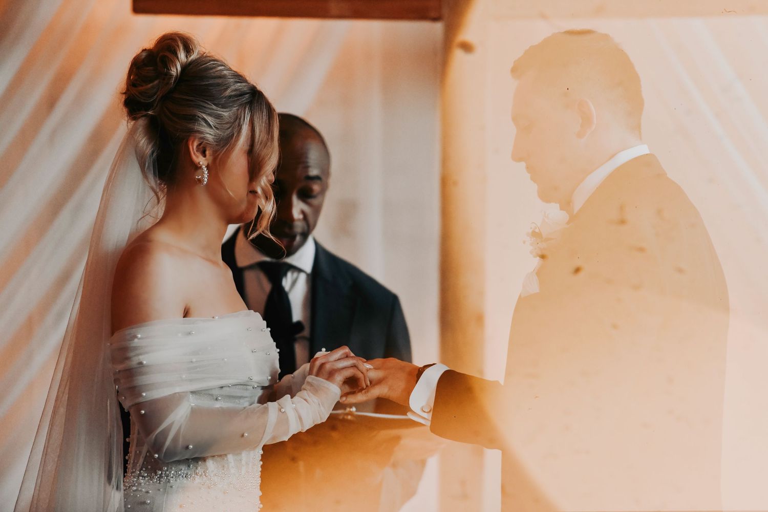 Close-up of bride and groom exchanging wedding rings