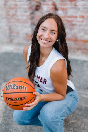 A series of casual portraits with a Wilson basketball against a rustic brick wall background.