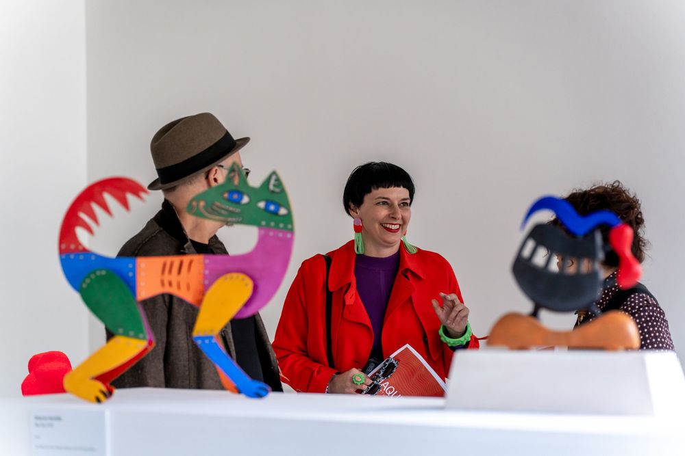 Colorful puppets arranged in a row against a white background creating a playful display.