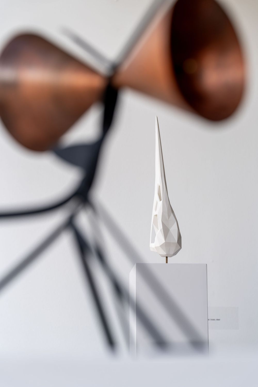 Minimalist close-up photo series showing white ceramic spoons against a light background in different angles and compositions.