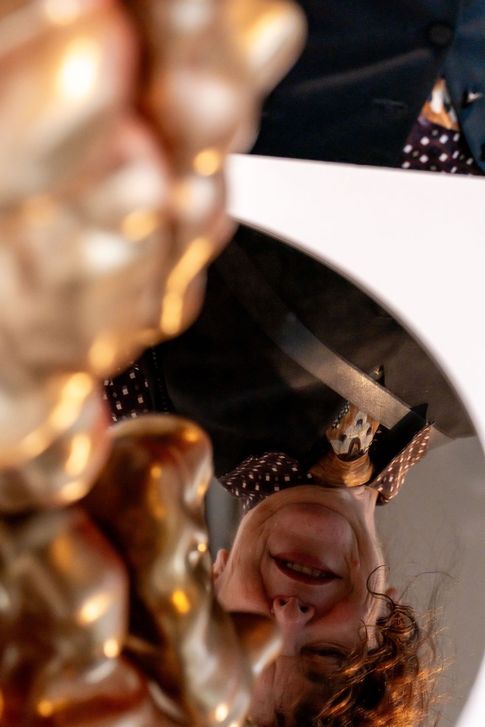 Close-up macro photography of reflective gold and brown surfaces creating an abstract pattern in warm tones.